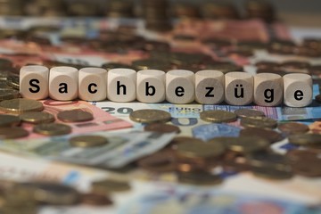 Wall Mural - sachbezüge - Holzwürfel mit Buchstaben im Hintergrund mit Geld, Geldscheine