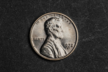 Close up of one american cent on black background - business concept