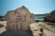 Sculpture carved in the rock at the beach Salinas in Ibiza