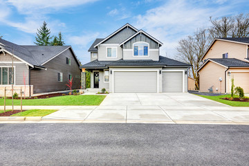 Grey house exterior on a blue sky background