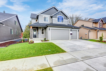 Grey house exterior on a blue sky background