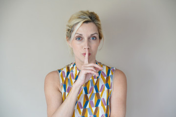 Blond woman expression on beige background, isolated