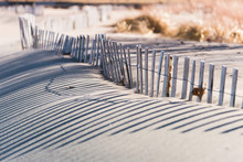 Crooked Wood Fence Protecting Native Beach Grass Along Lake Michigan Shore Line