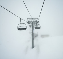Ski Chairlift Going Over A Mountain In Fog