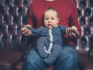 Wall Mural - Father with baby on sofa