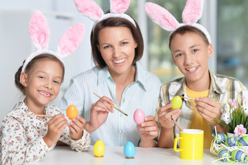 Wall Mural - Mother with children painting eggs