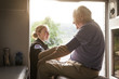 © Cavan Images - Paramedic examining senior patient in ambulance