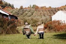 Senior Couple Picking Leaves In Park