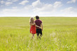 © Cavan Images - Young couple walking in meadow