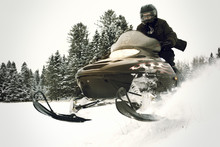 Man Riding Snowmobile