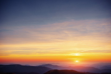 Wall Mural - colorful sky with sun background in mountains. sunset, sunrise