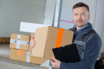 delivery man with parcel near cargo truck shipping service