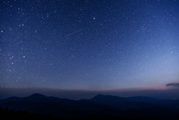 Wall Mural - fantastic winter meteor shower and the snow-capped mountains.