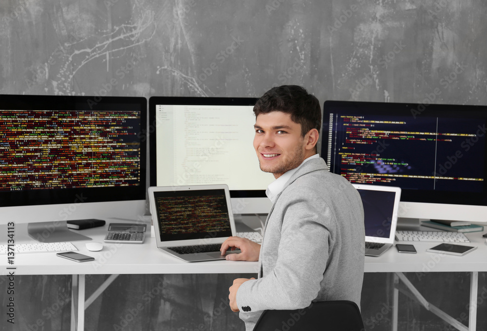 Handsome young programmer working in office Stock Photo | Adobe Stock