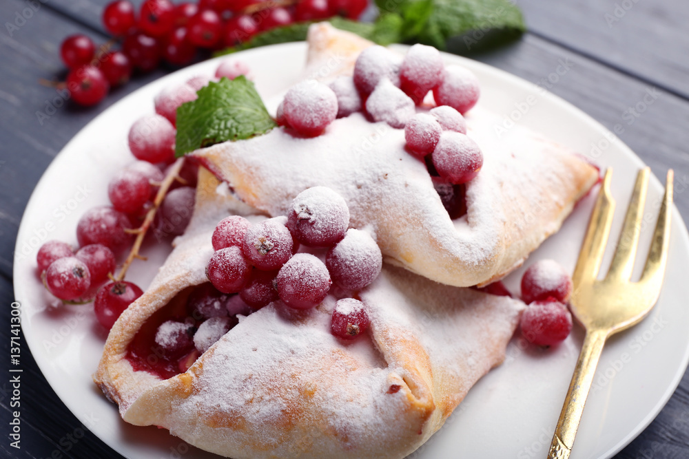 Tasty puff pastry with berries on plate