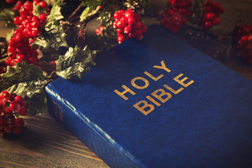 Wall Mural - Close up view of Bible and mistletoe branch on wooden table