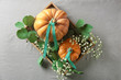 Pumpkin and gypsophila in wooden box on gray background, top view