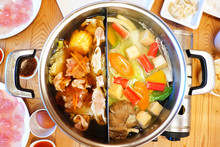 Double Flavor Hot Pot On Wood Background