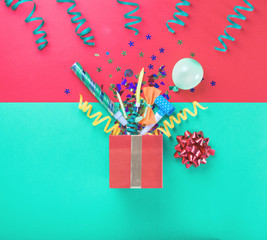 Red gift box with colorful party items