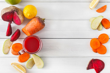 Natural detox beetroot smoothie with ingredients on white wood background