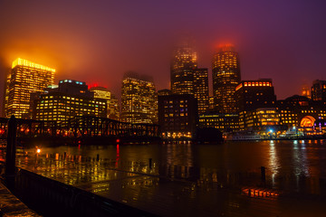 Autocollant - View of Boston skyscrapers night.  The tops of the buildings in the fog and haze. Rainy foggy weather, brilliant paving and lights of skyscrapers.
