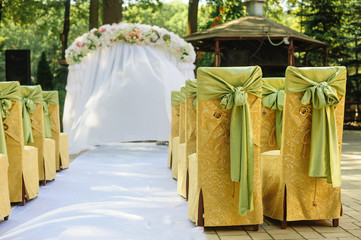 Wall Mural - Wedding arch in the yellow and green colors in a sunny day wedding