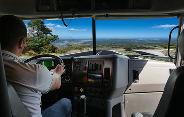 The truck driver on the road among fields highway. business trip