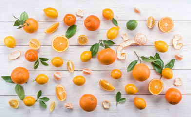 Wall Mural - Ripe lemons and oranges on the white wooden table.