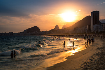 Wall Mural - Sunset View in Copacabana Beach with Mountains in Horizon and Tall Hotel Building, Rio de Janeiro
