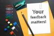 Text your feedback matters on white paper background / business concept