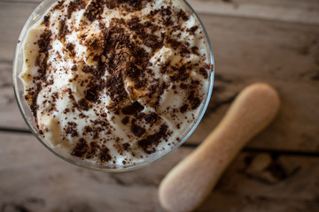 Wall Mural - Tiramisu in glass. Italian dessert. Beautiful wooden background.