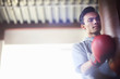 © Connect Images - Young male boxer punching punch bag in gym