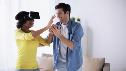 Wall Mural - happy couple with virtual reality headset at home