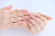 © nmelnychuk - Closeup of hands of a young woman with pink manicure on nails