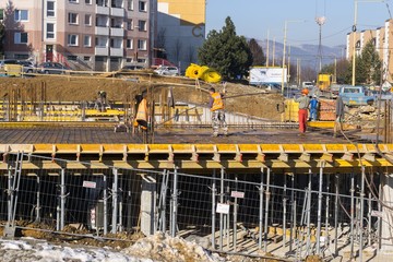 ZILINA, SLOVAKIA - FEBRUARY 14, 2017: Group of construction workers working together on a building constructions.