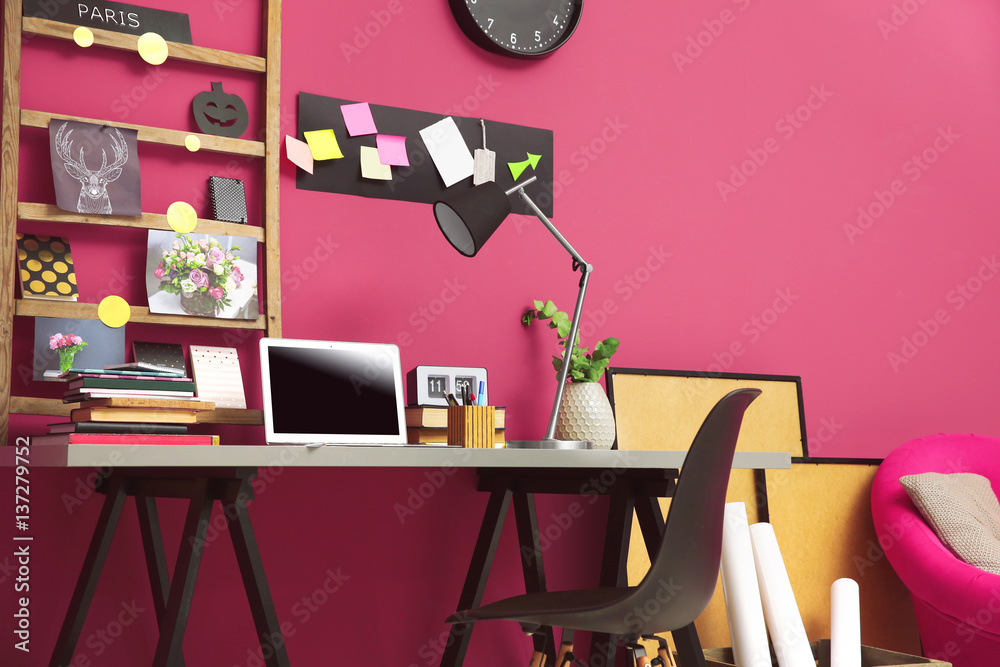 Workplace with laptop on table in modern room