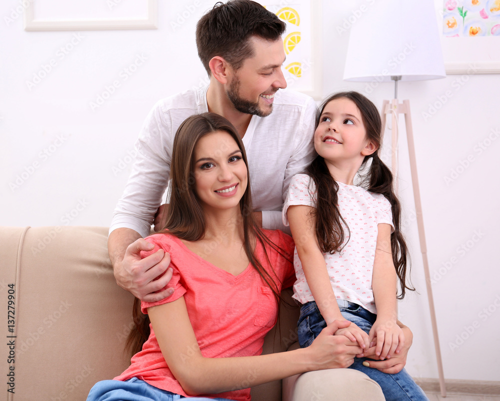 Happy family on sofa at home