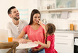 © Africa Studio - Happy parents and daughter on kitchen