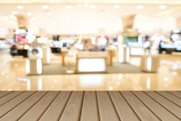  Empty wooden table over blurred shopping mall background, for product display montage.