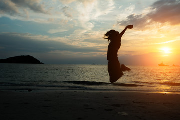 silhouette women jumping on the beach seaside.