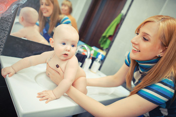 mother washes baby