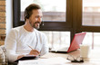 © zinkevych - Smiling bearded man using gadgets in the cafe