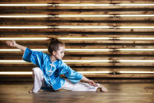 Pretty Little Girl In The Room In Sportswear For Martial Arts Is Wushu