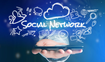 Concept of man holding smartphone with social network icon around