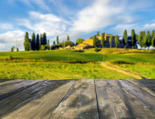 Wall Mural - wooden, empty table against the background of the Tuscan landscape