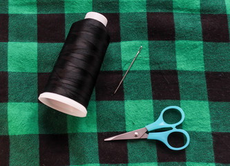 green lamberjack fabric with scissors and needle