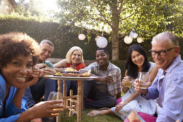 Wall Mural - Portrait Of Mature Friends Enjoying Drinks In Backyard