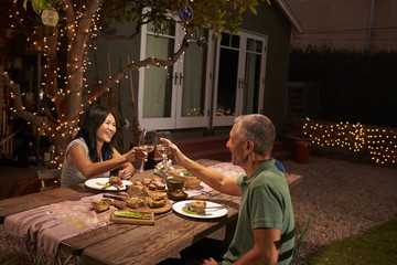 Wall Mural - Mature Couple Enjoying Outdoor Meal In Backyard