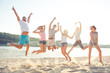 © deagreez - Group of happy young cheerful students jumping on the beach