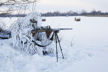 Varmint Hunter In Ghillie Snow Suit With Rifle On Bipod In Winter
